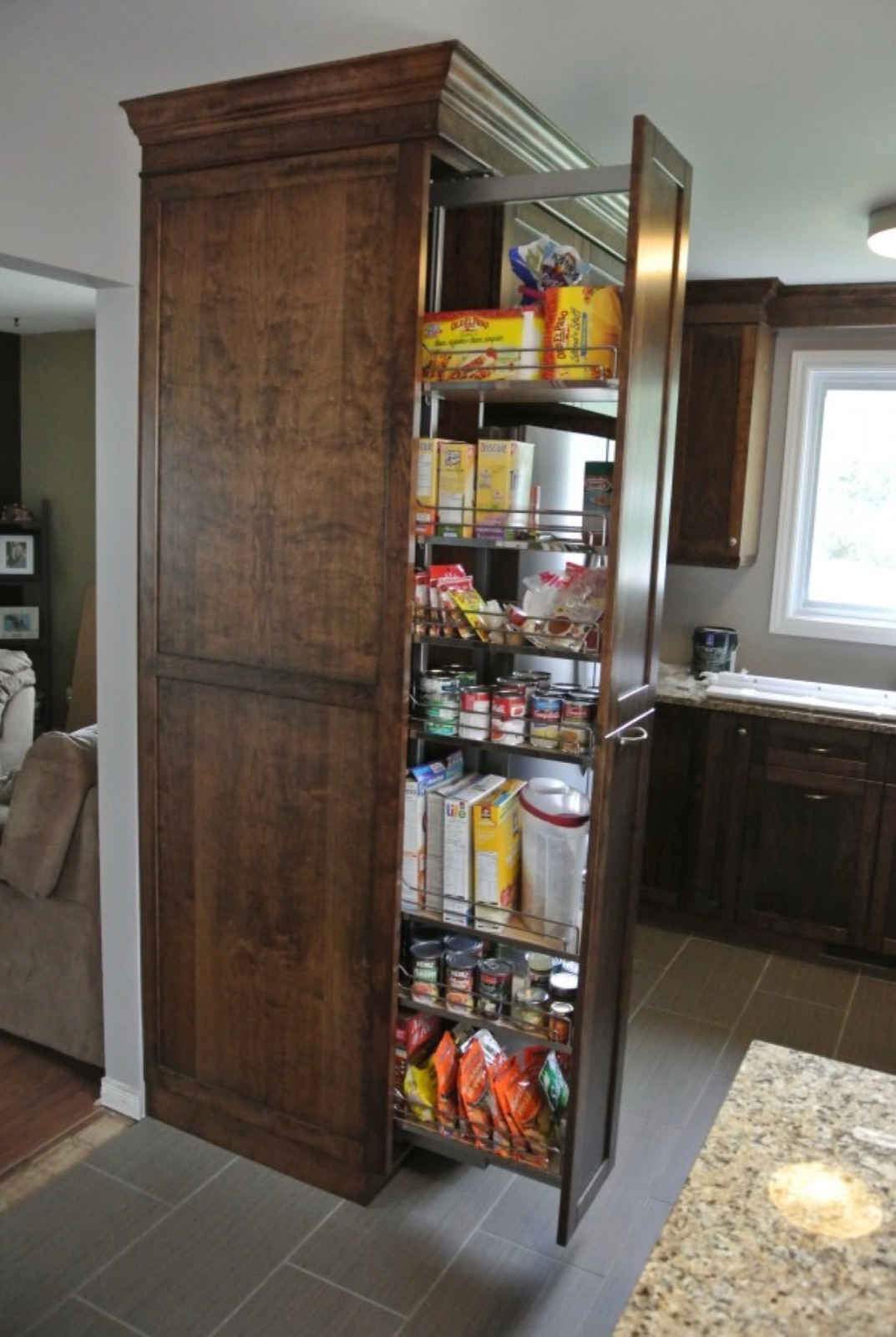 Reference photo of a tall pull-out pantry cabinet with wire baskets, from a different kitchen.
