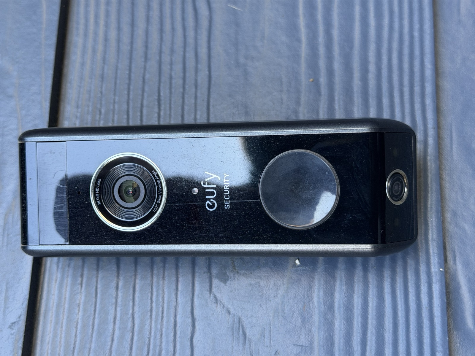 Eufy Security video doorbell showing the main 2K wide-angle lens on the left and a secondary lens near the right edge for a lower, package-framing view.